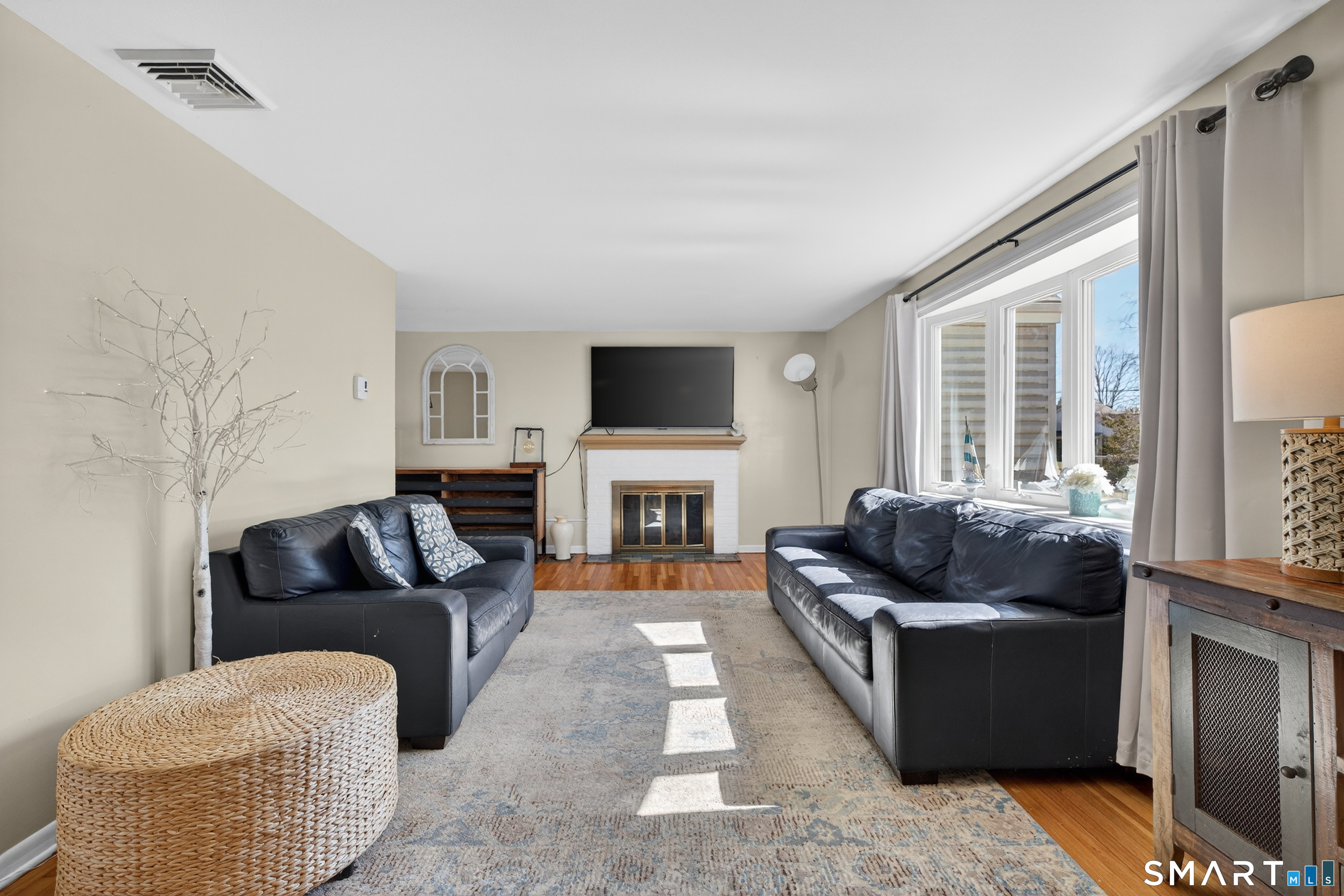 18 Riverside Terrace Madison, CT 06443 - Photo 5 of 40 a living room with furniture and a flat screen tv