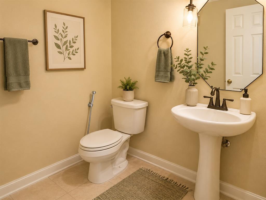 5708 Rickshaw Lane Plano, TX 75094 - Photo 8 of 28 Pedestal sink with bronze-finish faucet, octagonal mirror, and wall-mounted light fixture