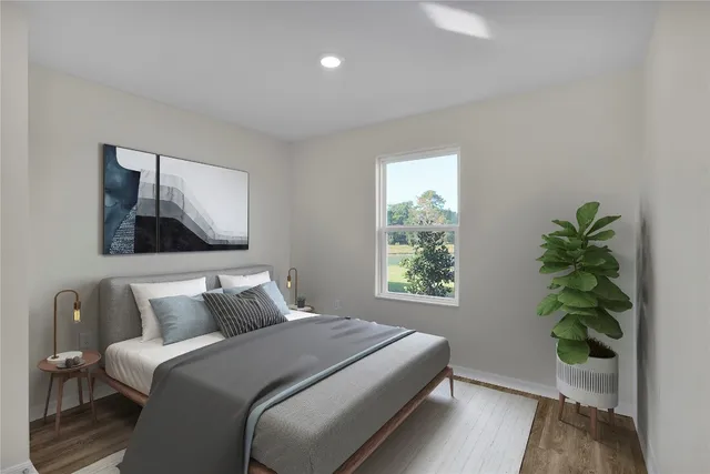 a bedroom with a bed and a potted plant