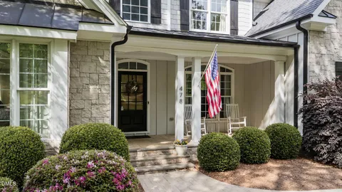 front view of a brick house with a yard