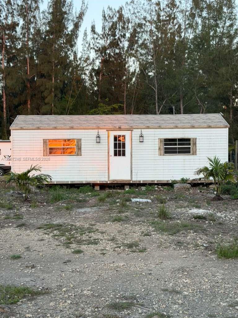 14370 Southwest 208th Avenue Miami, FL 33196 - Photo 9 of 19 a view of a white house with a yard
