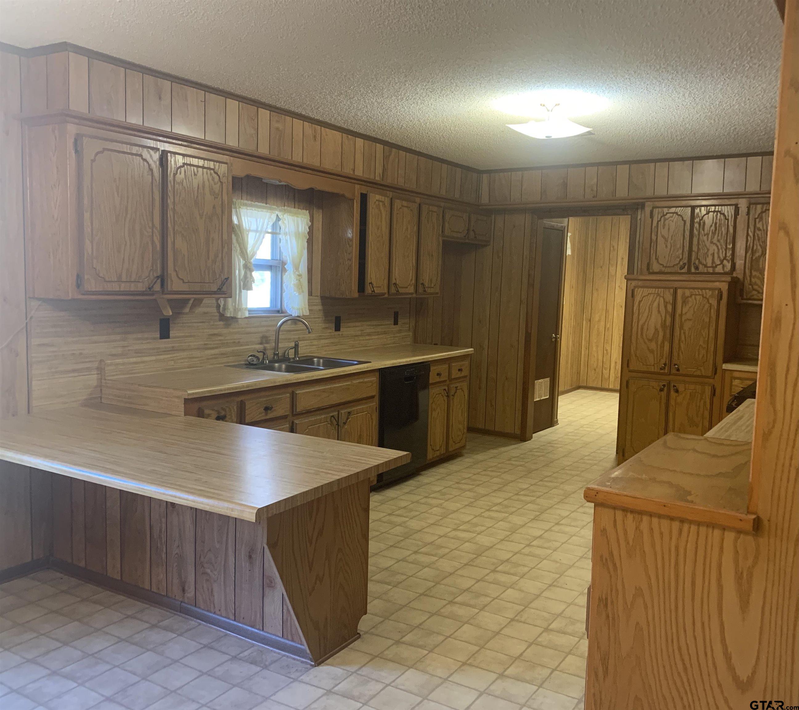 304 6th Street Southwest Bogata, TX 75417 - Photo 11 of 30 a kitchen with stainless steel appliances granite countertop a sink and a refrigerator