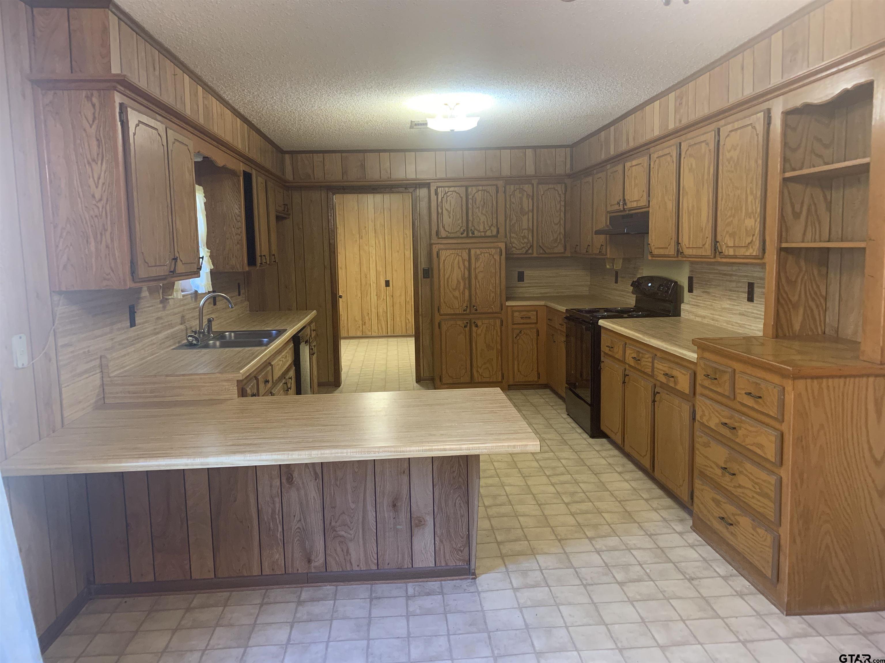 304 6th Street Southwest Bogata, TX 75417 - Photo 13 of 30 a kitchen with a sink stove and cabinets