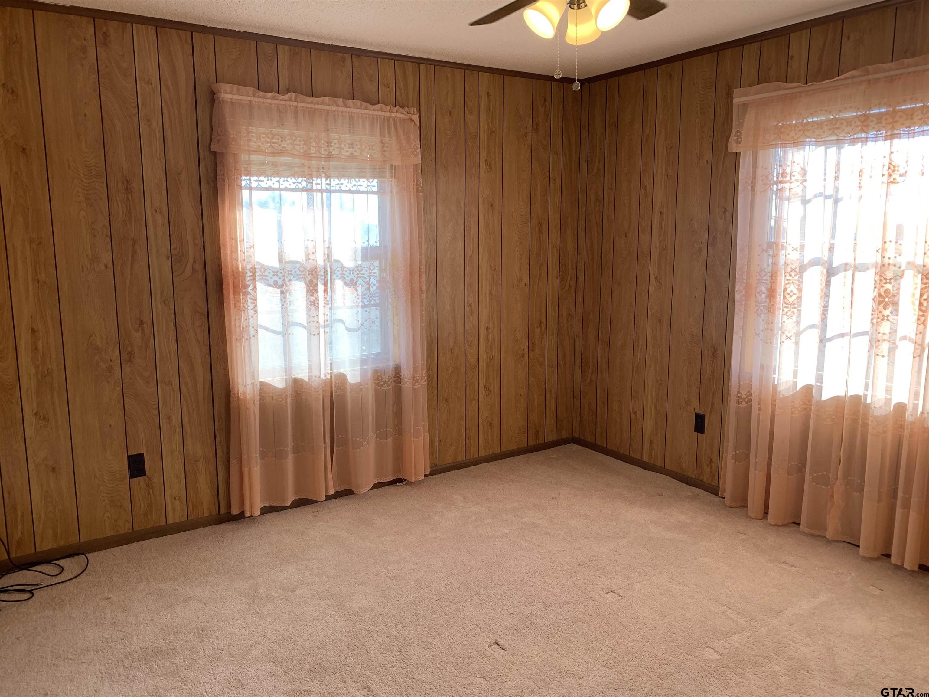 304 6th Street Southwest Bogata, TX 75417 - Photo 24 of 30 an empty room with windows chandelier fan
