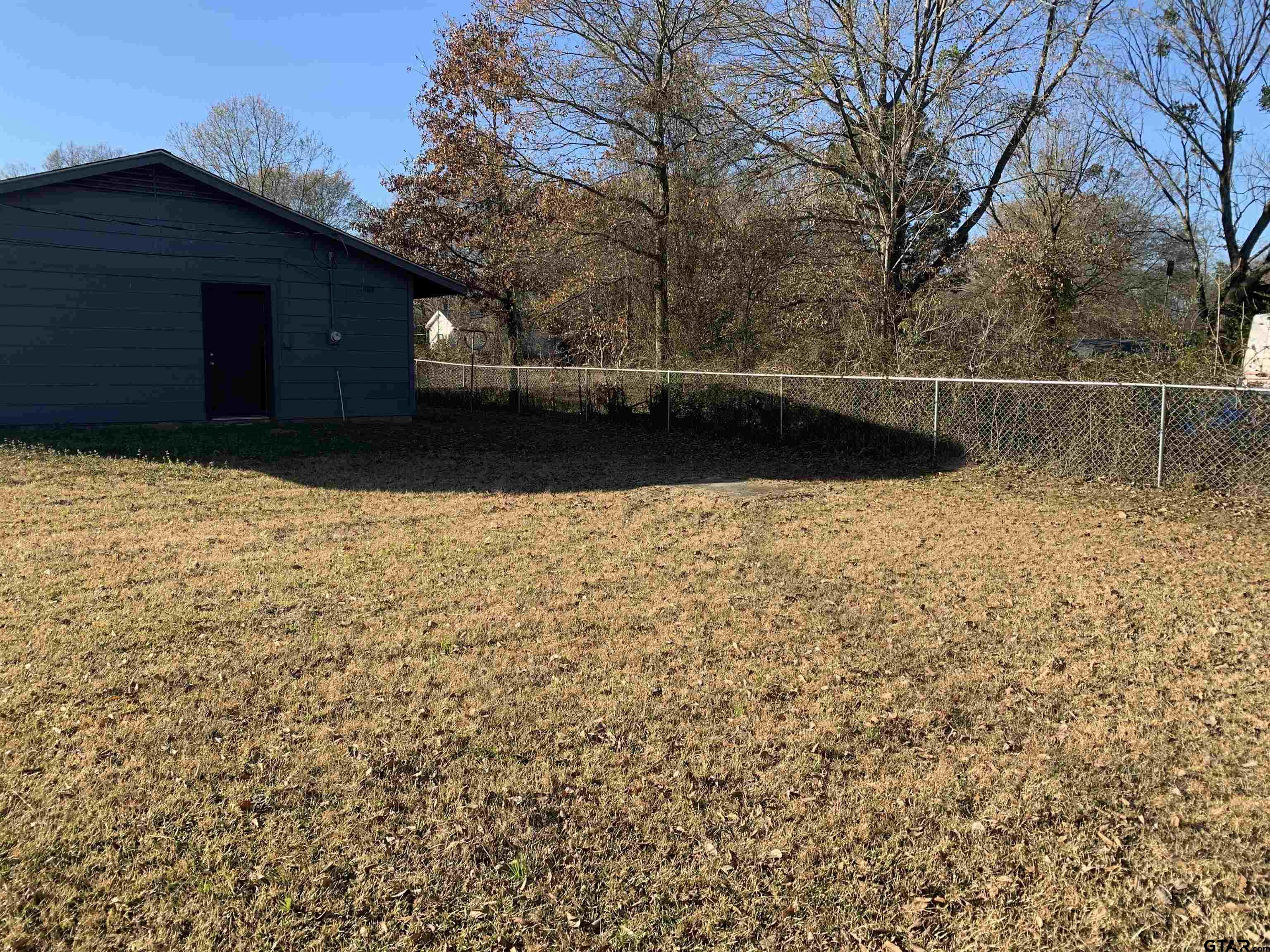 304 6th Street Southwest Bogata, TX 75417 - Photo 27 of 30 a view of backyard with wooden fence