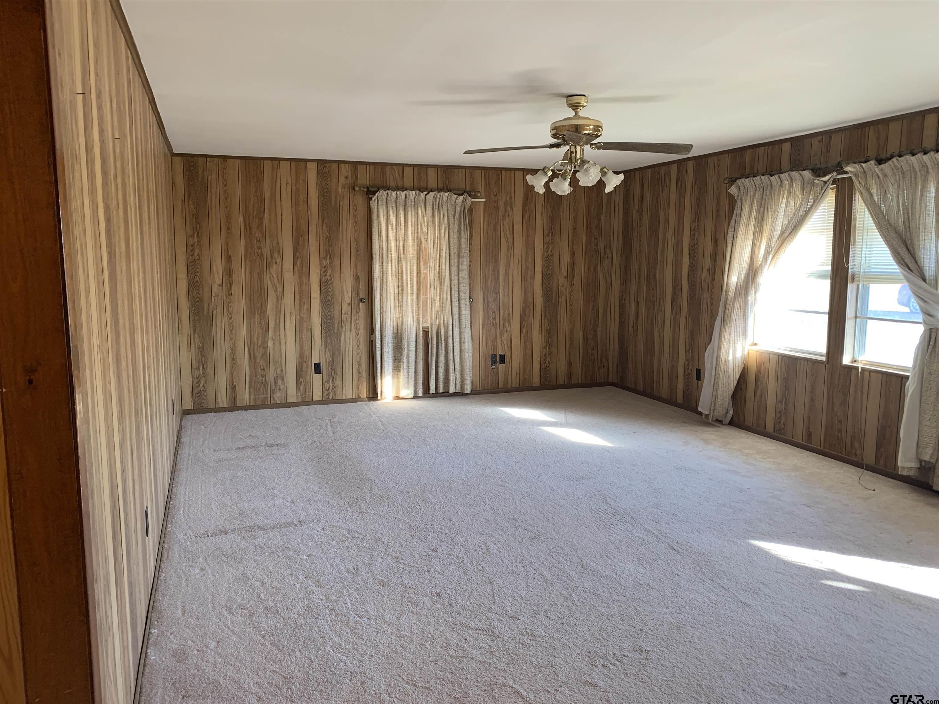304 6th Street Southwest Bogata, TX 75417 - Photo 5 of 30 an empty room with windows and fan