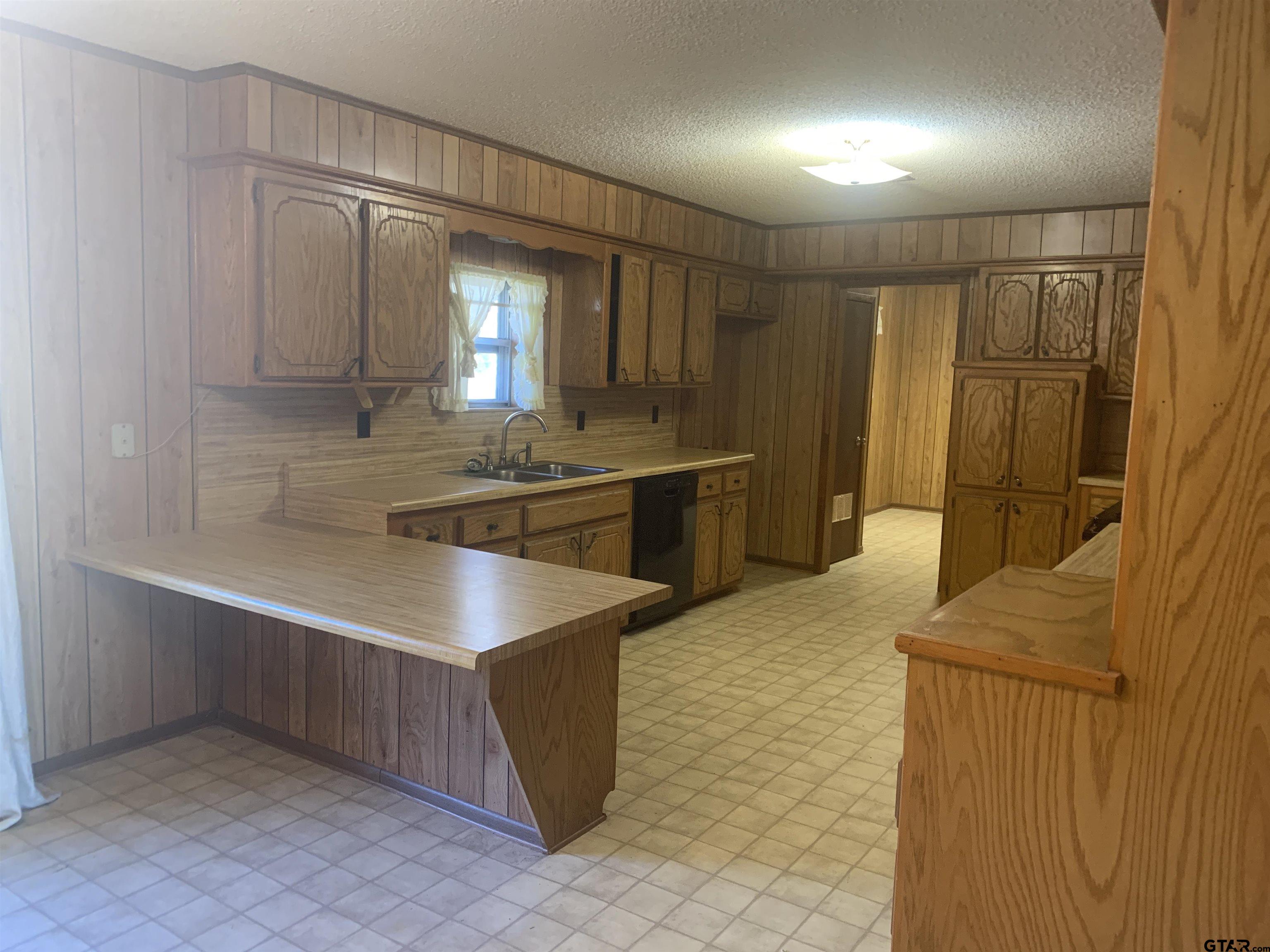 304 6th Street Southwest Bogata, TX 75417 - Photo 10 of 30 a kitchen with stainless steel appliances granite countertop a sink and a refrigerator