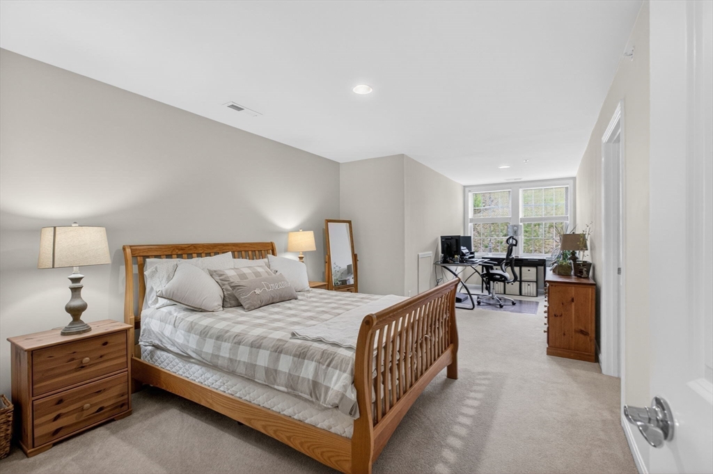87 Shannon Way, Unit 86 Upton, MA 01568 - Photo 27 of 36 a bedroom with bed and a table