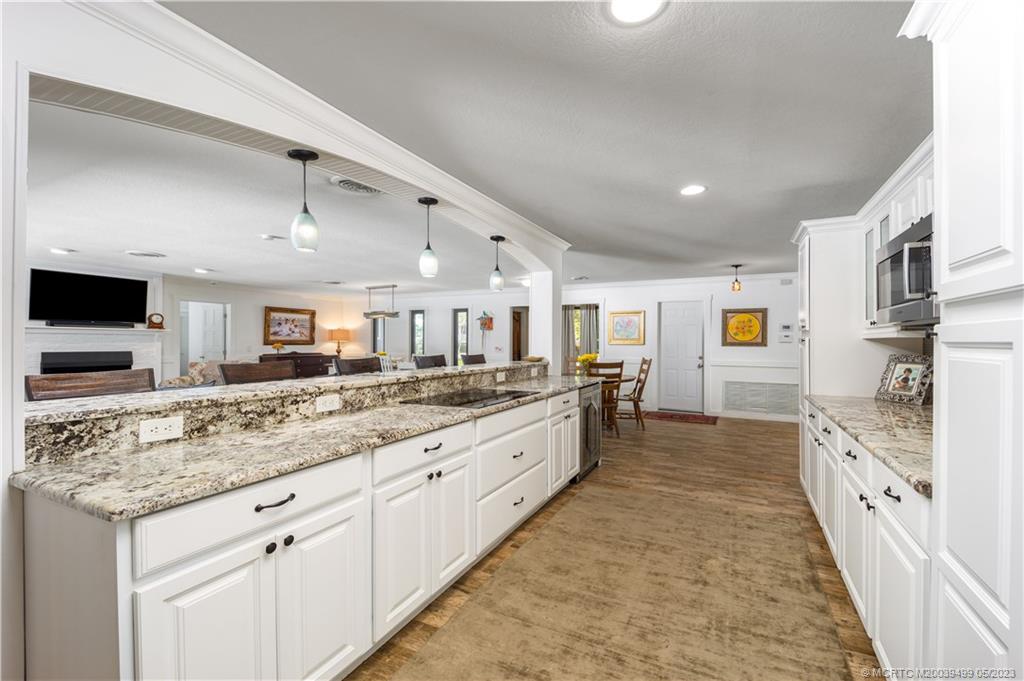 4 Ridgeview Road North Stuart, FL 34996 - Photo 20 of 57 a large white kitchen with stainless steel appliances kitchen island granite countertop a large counter top and a sink