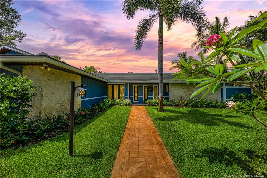 4 Ridgeview Road North Stuart, FL 34996 - Photo 2 of 57 a front view of a house with a yard and potted plants