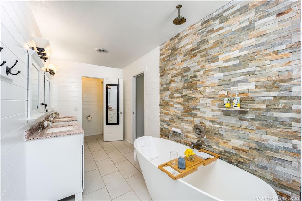 4 Ridgeview Road North Stuart, FL 34996 - Photo 32 of 57 a bathroom with a tub sink and mirror