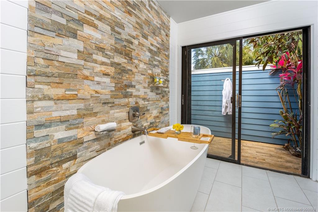 4 Ridgeview Road North Stuart, FL 34996 - Photo 34 of 57 a bathroom with a tub and shower