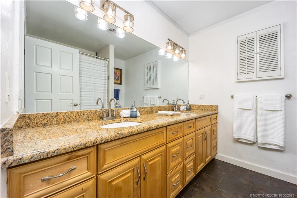 4 Ridgeview Road North Stuart, FL 34996 - Photo 38 of 57 a bathroom with a granite countertop double vanity sink and a mirror