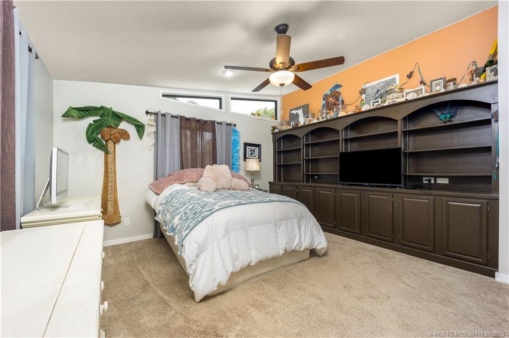 4 Ridgeview Road North Stuart, FL 34996 - Photo 39 of 57 a spacious bedroom with a bed and a cabinets