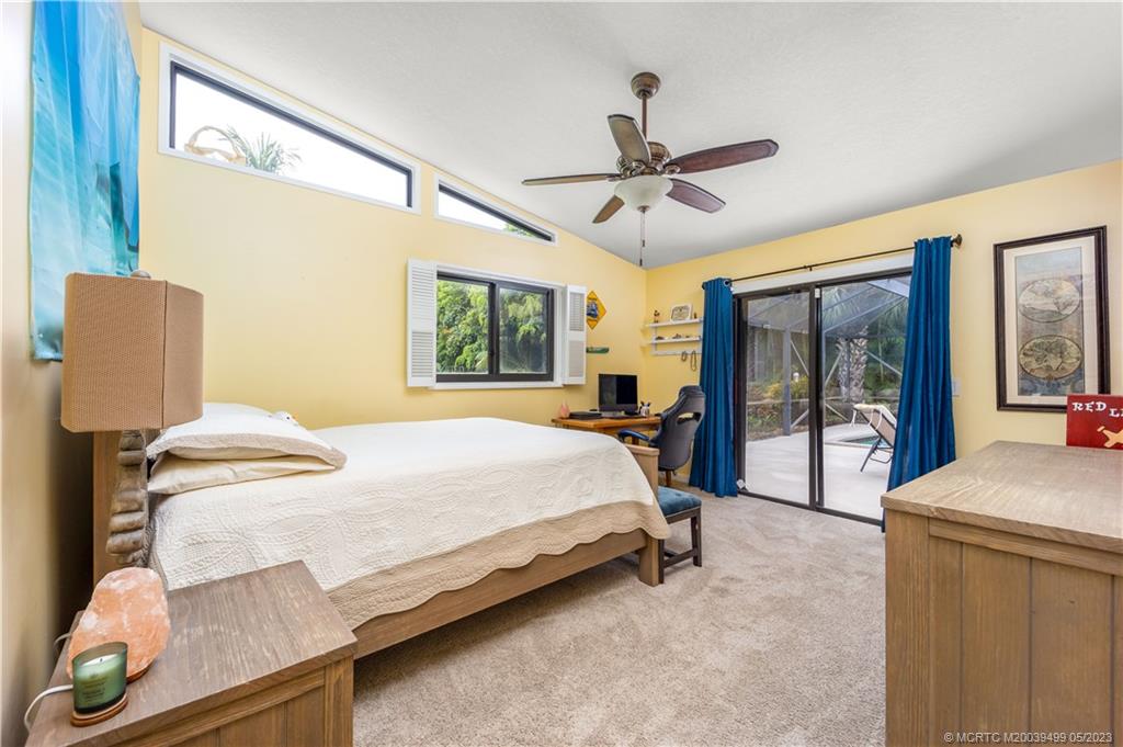 4 Ridgeview Road North Stuart, FL 34996 - Photo 40 of 57 a bedroom with a bed and large windows