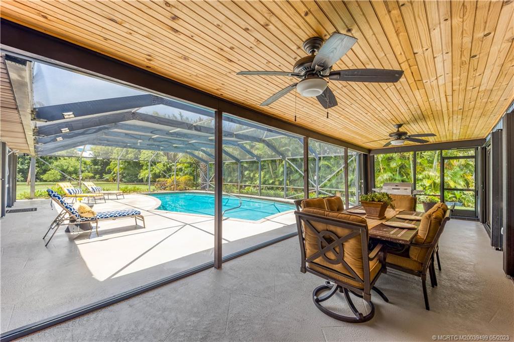 4 Ridgeview Road North Stuart, FL 34996 - Photo 43 of 57 a dining room with furniture and a garden view