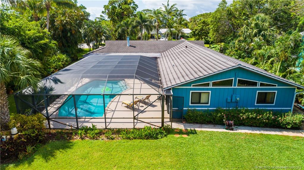 4 Ridgeview Road North Stuart, FL 34996 - Photo 9 of 57 a view of a backyard with plants and a garden