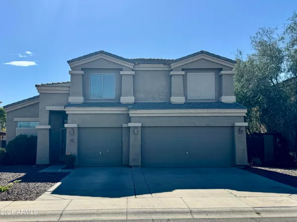 a view of a house with a yard and garage