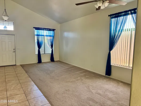 an empty room with windows and closet