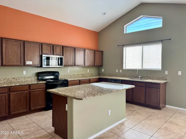 a kitchen with stainless steel appliances granite countertop a stove sink and cabinets