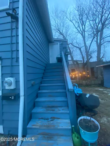 a view of a house with backyard and wooden fence