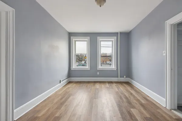 a view of room with window and hardwood floor