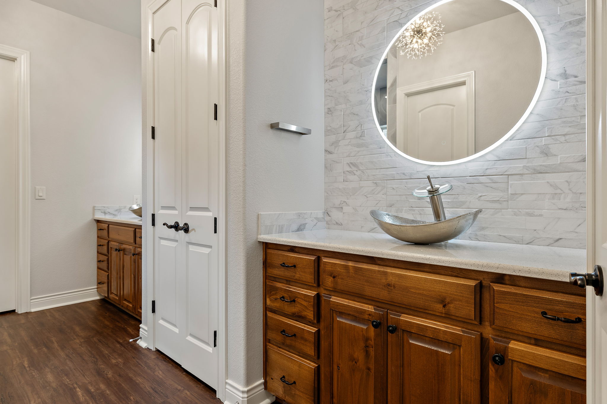 231 Marbella Way Georgetown, TX 78633 - Photo 20 of 40 Dual vanities with vessel sinks and rich wood cabinetry create a luxurious and functional bathroom space.