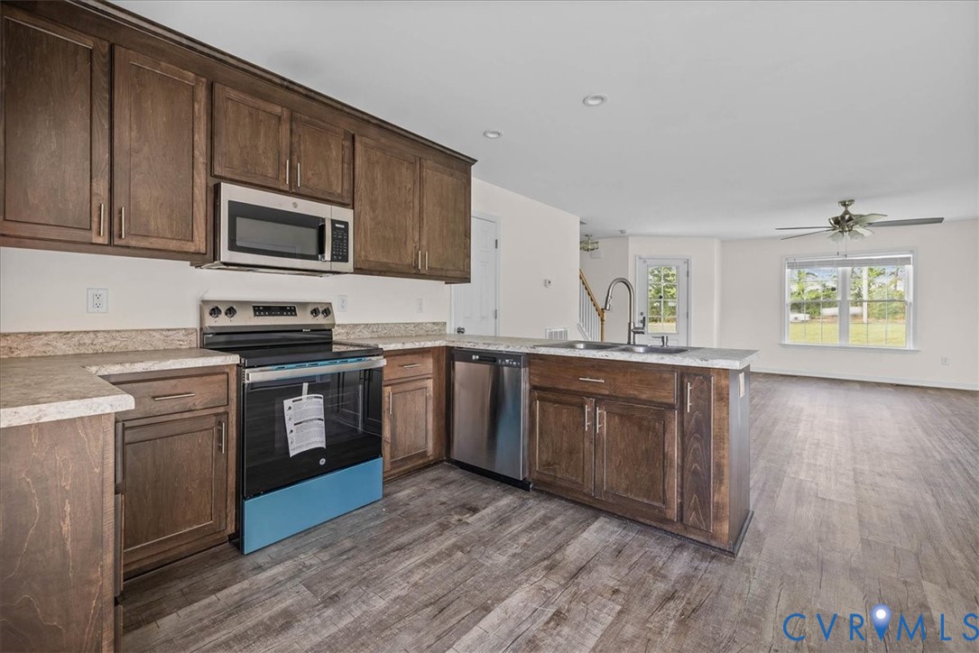11325 Webb Road Disputanta, VA 23842 - Photo 10 of 32 a kitchen with stainless steel appliances granite countertop a stove a sink and a microwave