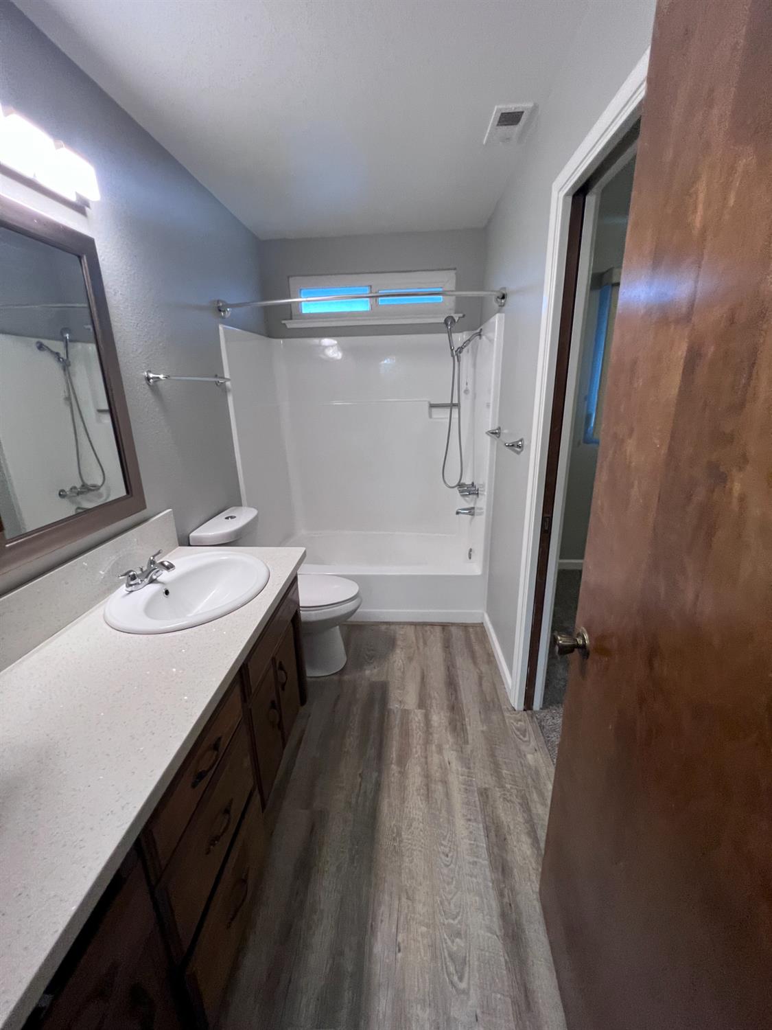 410 Pine Street Ripon, CA 95366 - Photo 13 of 16 a bathroom with a sink a toilet a mirror and shower