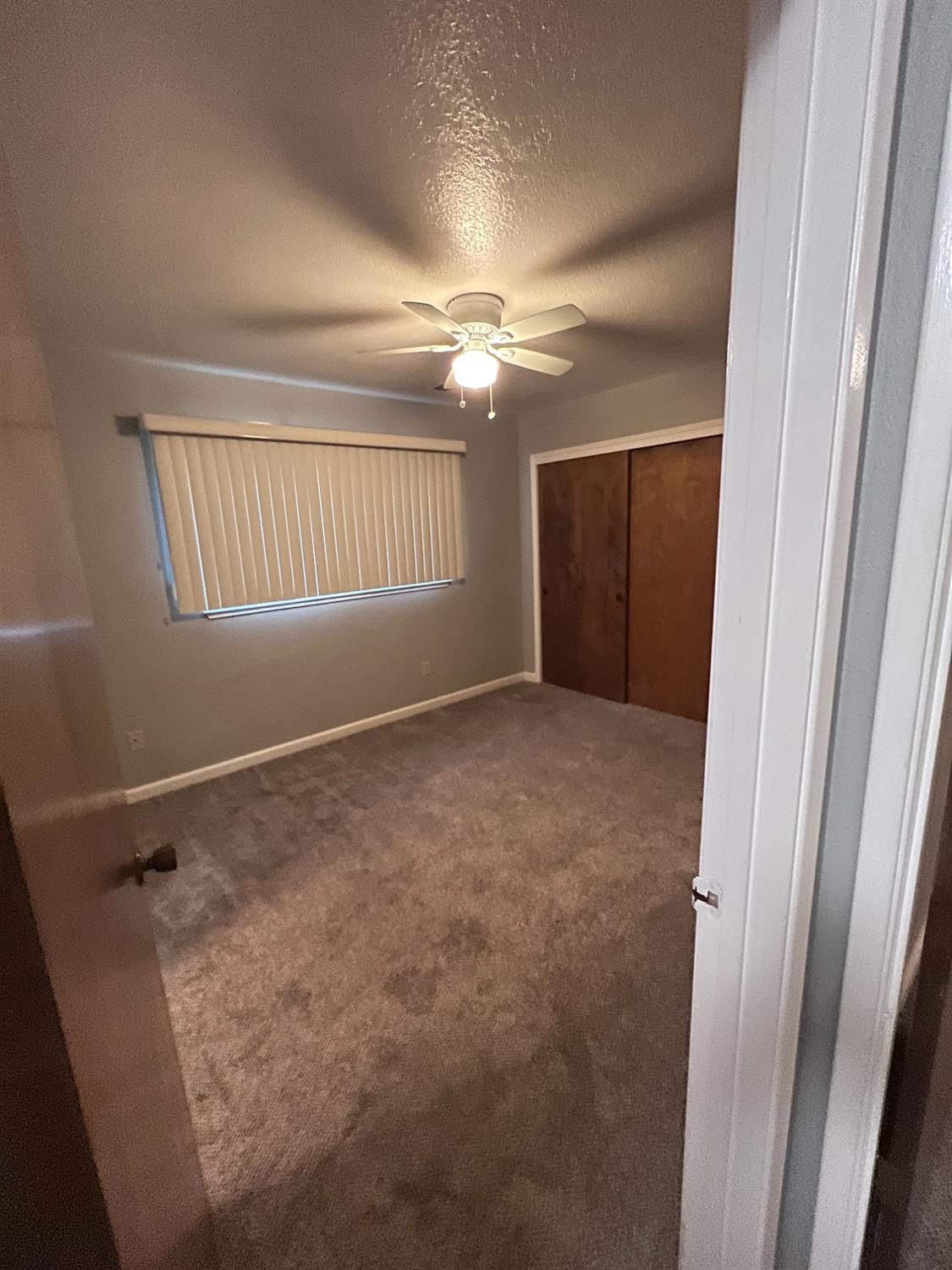 410 Pine Street Ripon, CA 95366 - Photo 15 of 16 en empty room with windows and fan