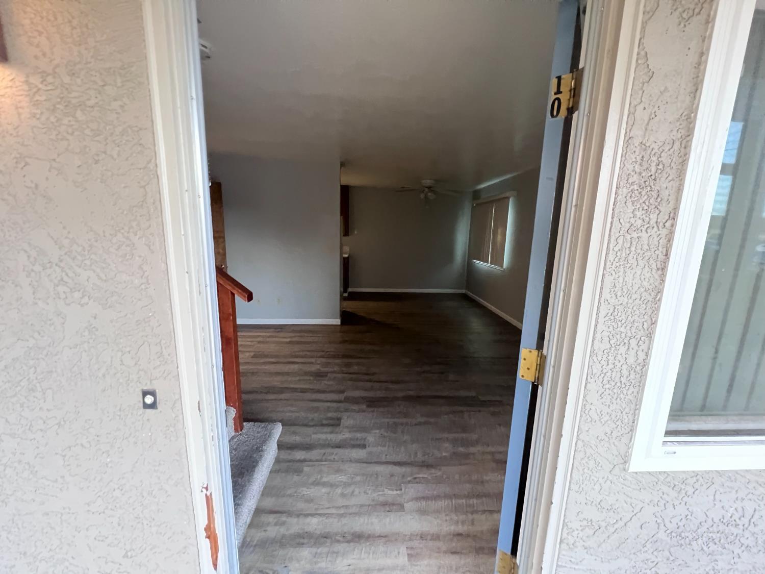 410 Pine Street Ripon, CA 95366 - Photo 5 of 16 a view of a hallway with wooden floor and staircase