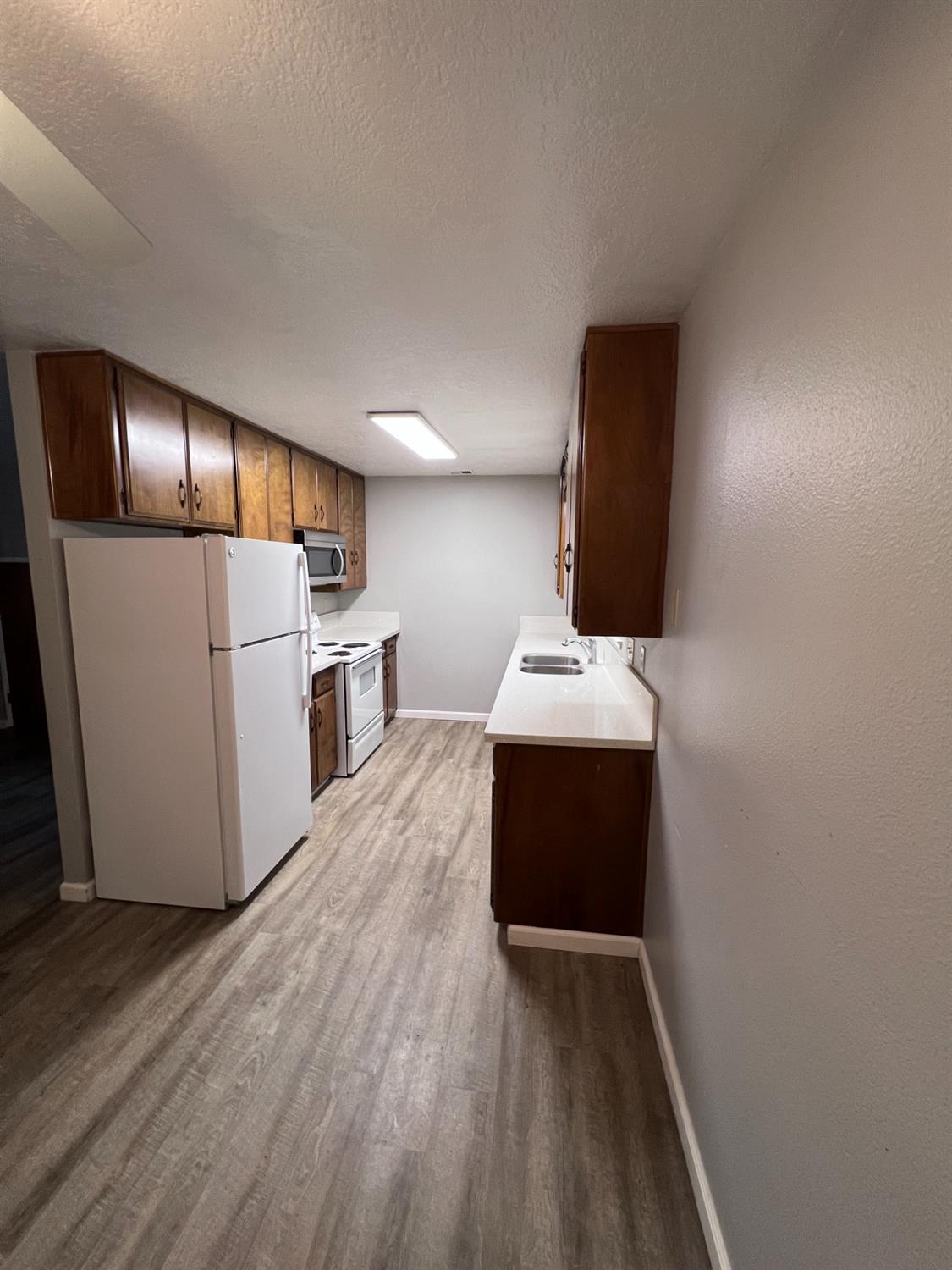 410 Pine Street Ripon, CA 95366 - Photo 7 of 16 a kitchen with a refrigerator and a sink
