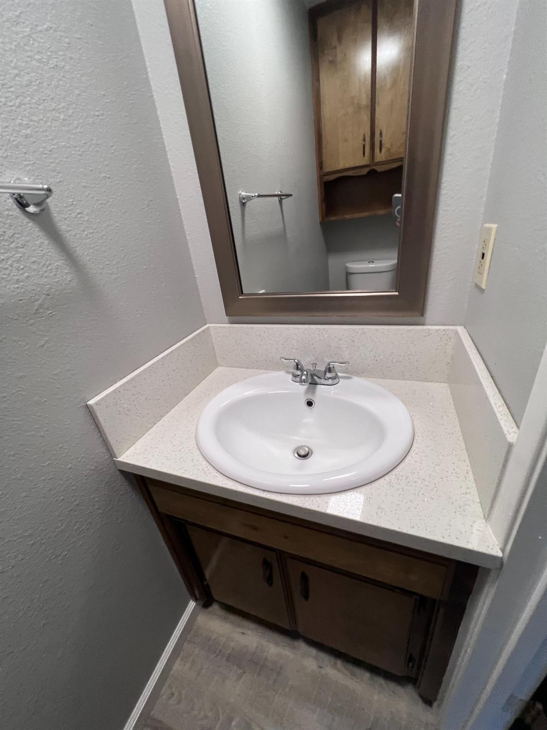 410 Pine Street Ripon, CA 95366 - Photo 8 of 16 a bathroom with a sink and a mirror