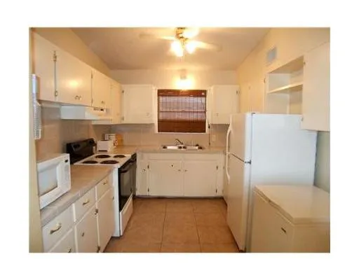 a kitchen with a sink cabinets and window