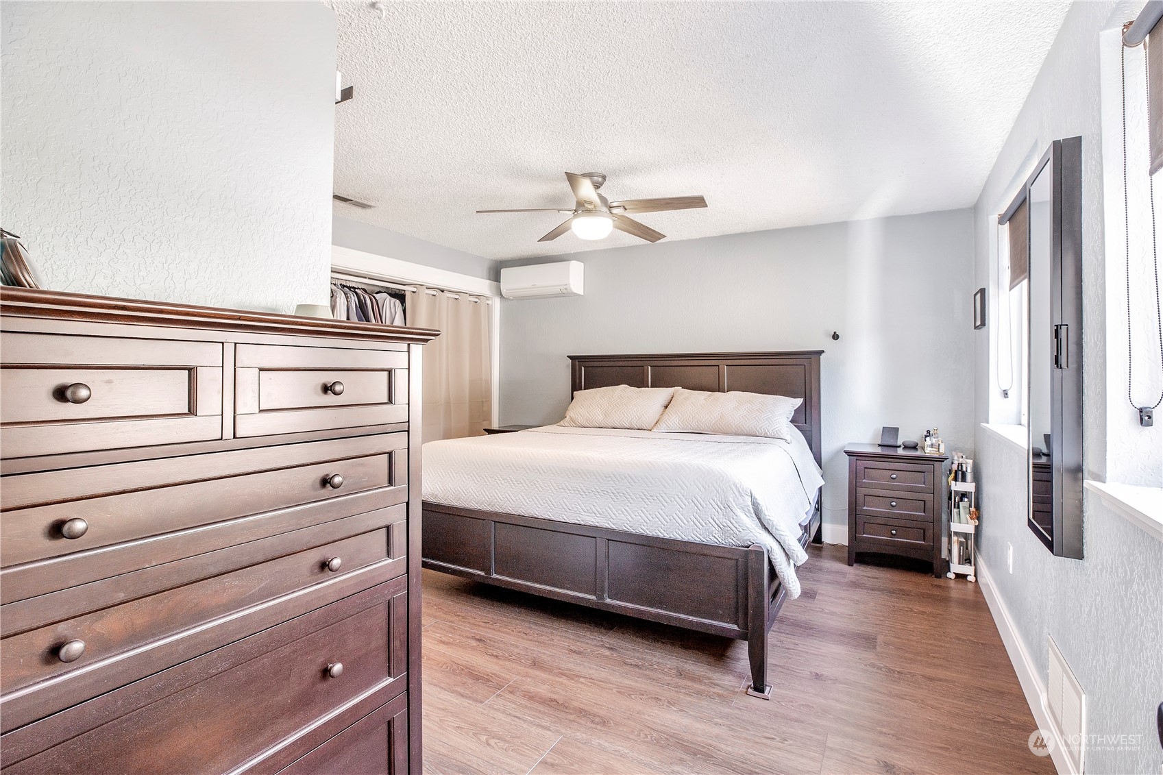 1826 225th Street Southeast Bothell, WA 98021 - Photo 21 of 33 a bedroom with a bed and wooden floor