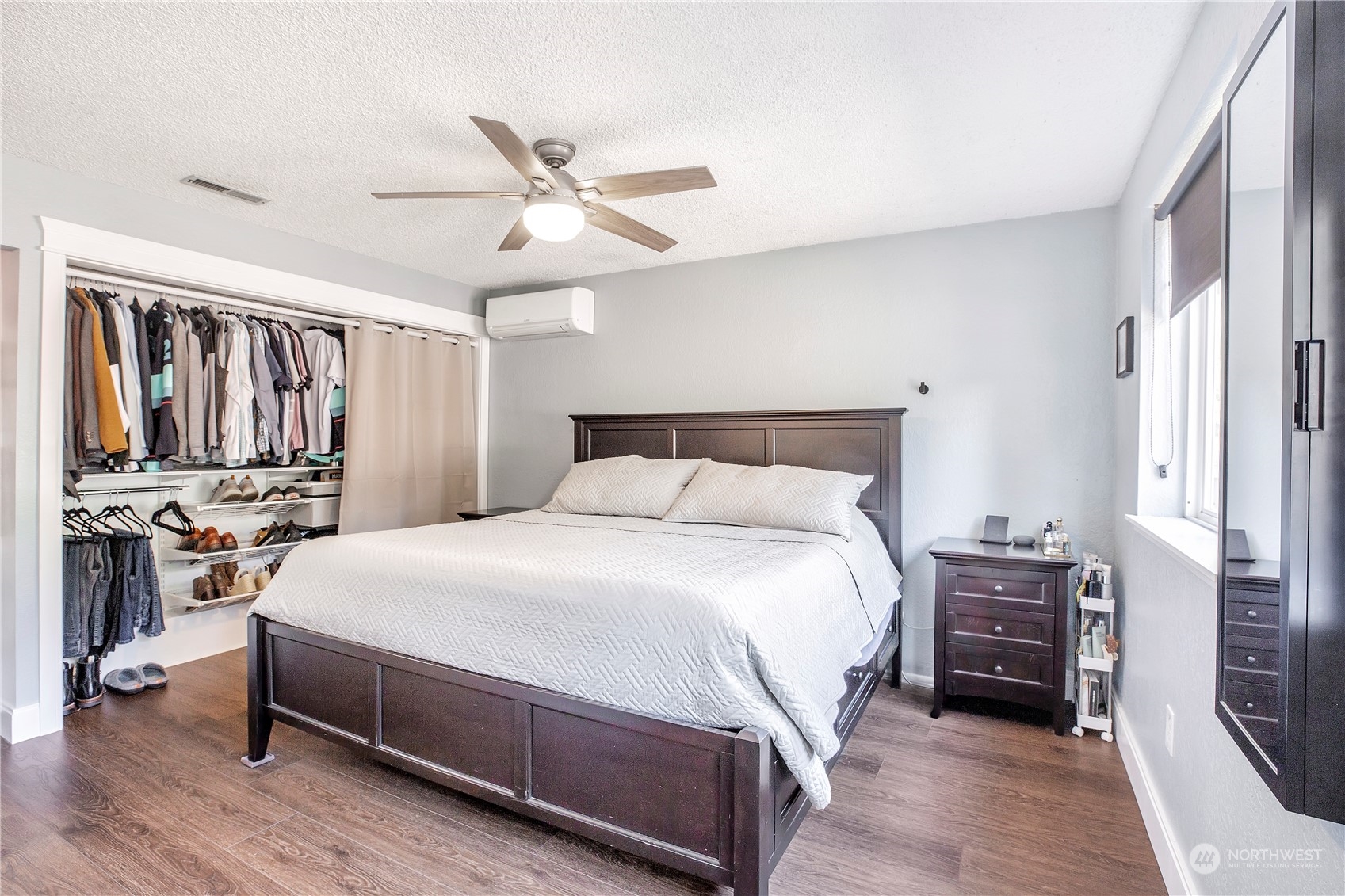 1826 225th Street Southeast Bothell, WA 98021 - Photo 22 of 33 a bedroom with a bed and a chandelier