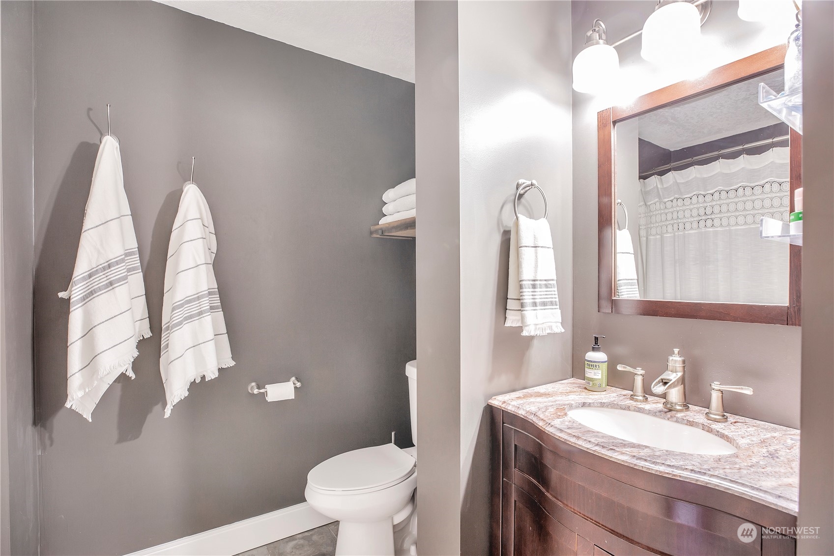 1826 225th Street Southeast Bothell, WA 98021 - Photo 23 of 33 a bathroom with a granite countertop sink a toilet and a mirror