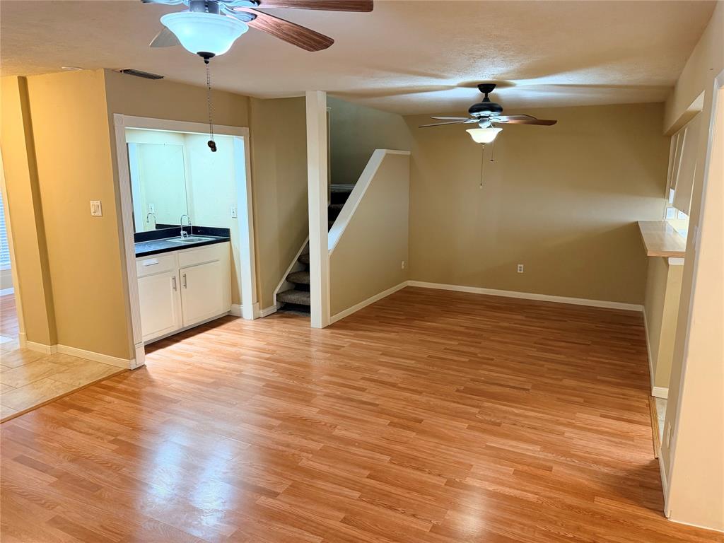 2051 Embassy Way Carrollton, TX 75006 - Photo 3 of 20 Unfurnished living room featuring light wood-type flooring and ceiling fan