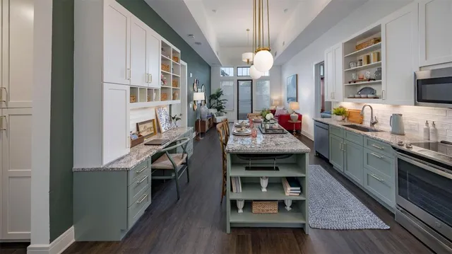 a kitchen with stainless steel appliances granite countertop a stove and cabinets