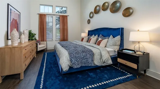 a bed room with a bed mirror and a window