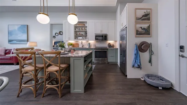 a view of a dining room with furniture and wooden floor