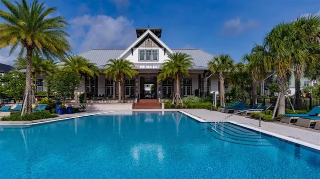 a view of a house with swimming pool and sitting area