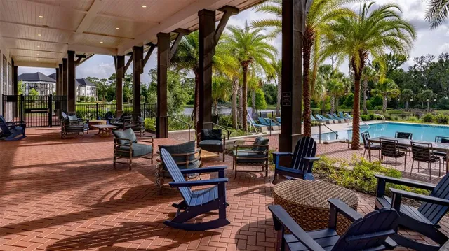 a view of a patio with swimming pool table and chairs