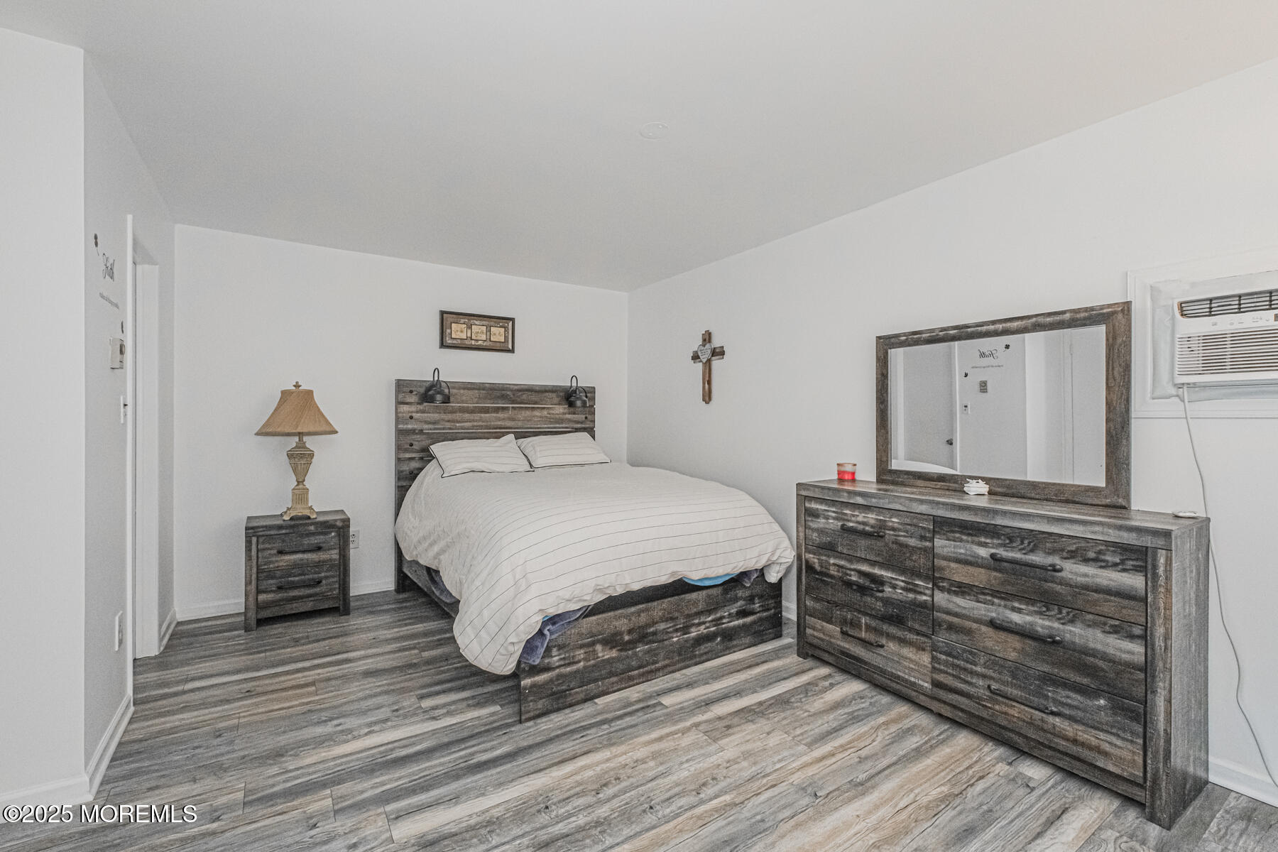 75 Overlook Way, Unit K Manalapan, NJ 07726 - Photo 18 of 24 a bedroom with a bed and wooden floor