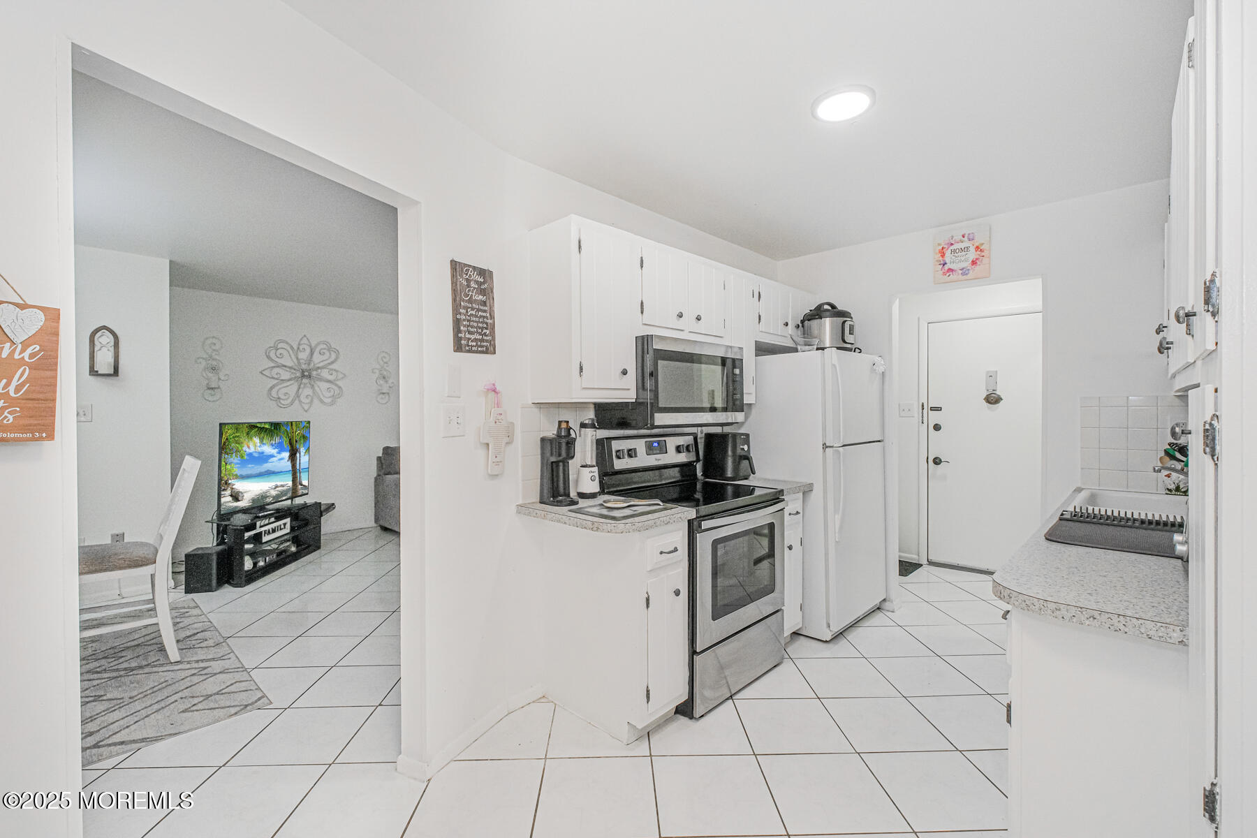 75 Overlook Way, Unit K Manalapan, NJ 07726 - Photo 5 of 24 a kitchen with granite countertop a refrigerator and a stove top oven
