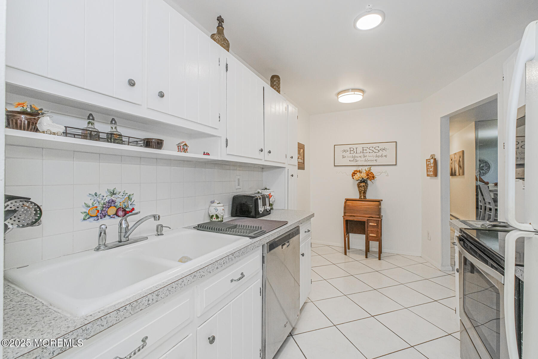 75 Overlook Way, Unit K Manalapan, NJ 07726 - Photo 7 of 24 a kitchen with a sink a stove and cabinets