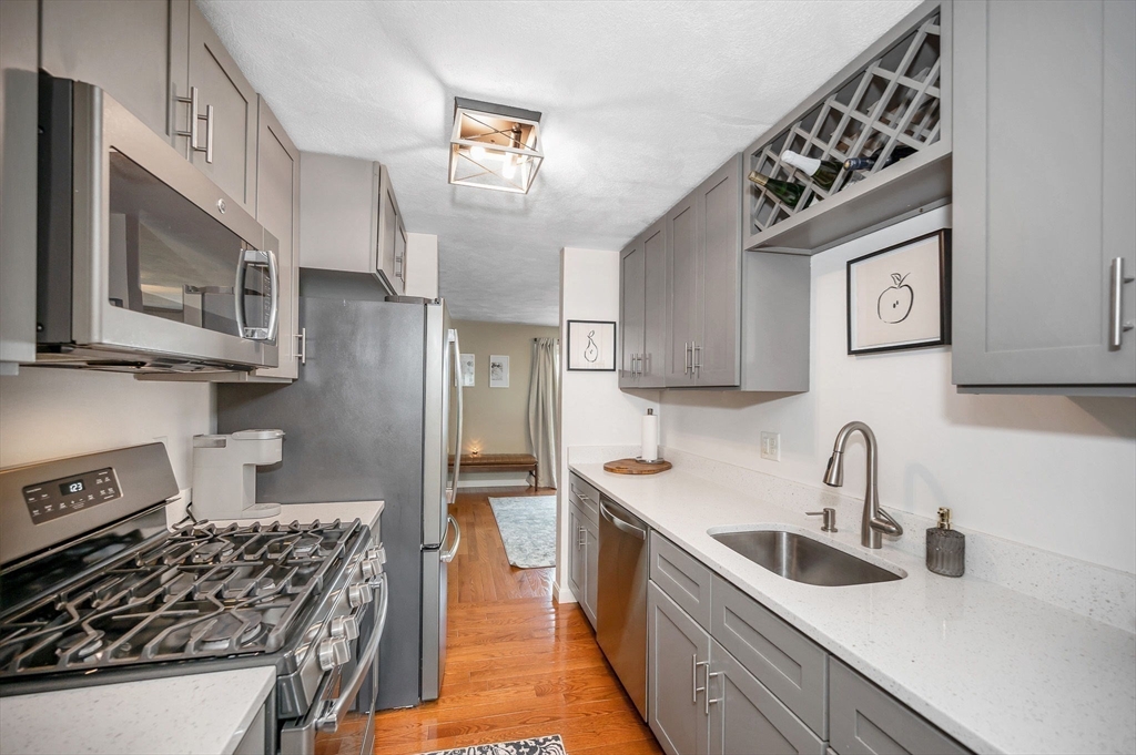 31 Patrick Road, Unit 31 Tewksbury, MA 01876 - Photo 11 of 40 a kitchen with stainless steel appliances a sink a stove and cabinets
