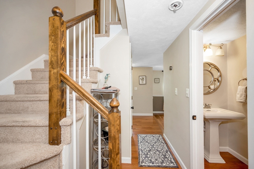 31 Patrick Road, Unit 31 Tewksbury, MA 01876 - Photo 14 of 40 a view of a hallway with windows and stairs