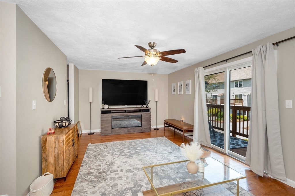 31 Patrick Road, Unit 31 Tewksbury, MA 01876 - Photo 16 of 40 a living room with furniture and a flat screen tv