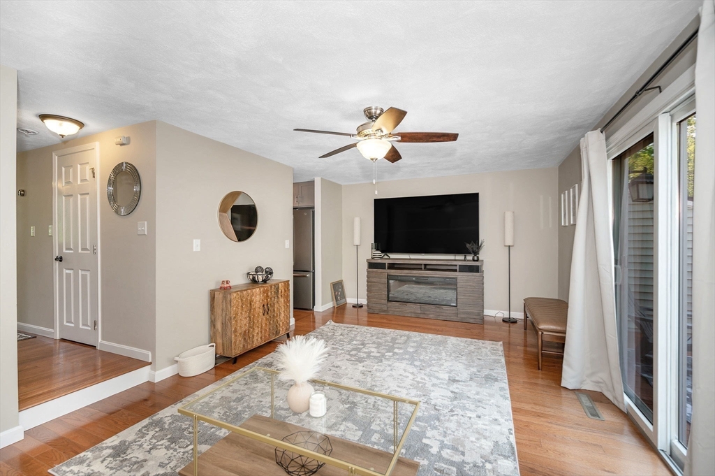 31 Patrick Road, Unit 31 Tewksbury, MA 01876 - Photo 18 of 40 a living room with furniture and a flat screen tv